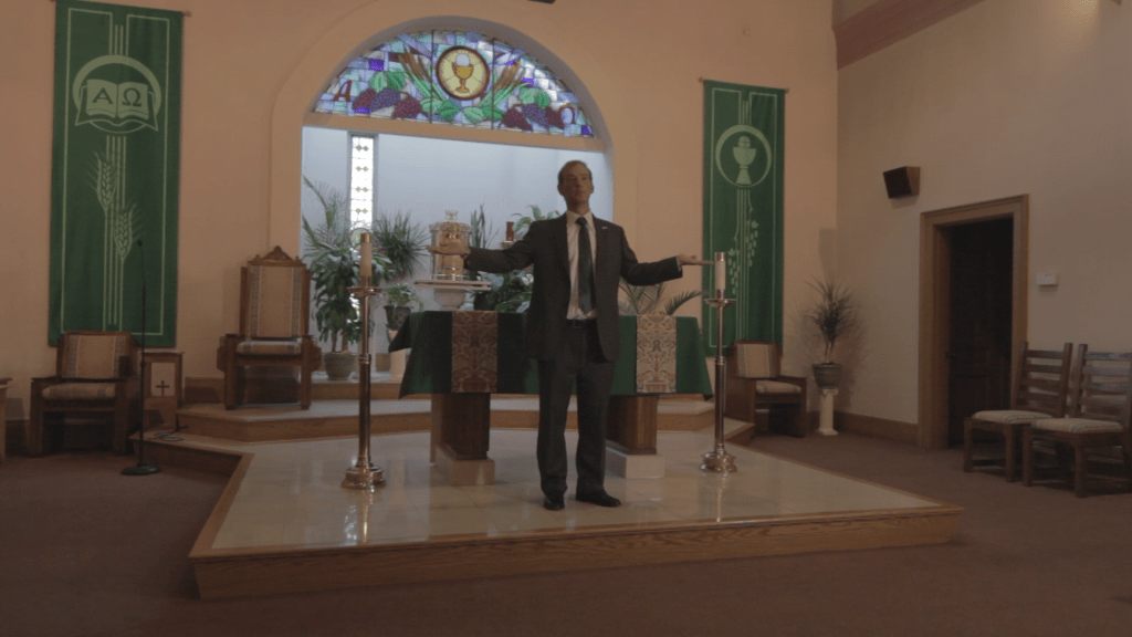 POV. Henri Miller watches his father Joseph in church.