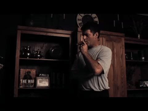 Henri Miller enjoys a cigar in Justice Is Mind.